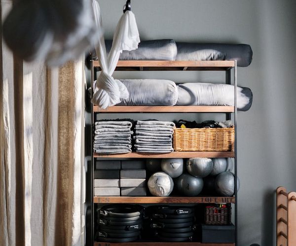 Neatly arranged yoga props including blocks, straps, and blankets.